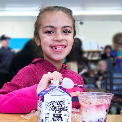 Elementary school student eating breakfast in the classroom in Amherst