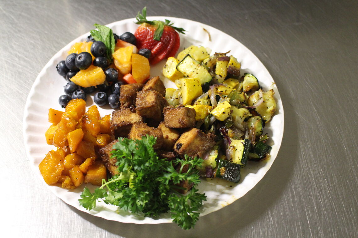 tofu salad plate with greens, fruits, tofu, and squash